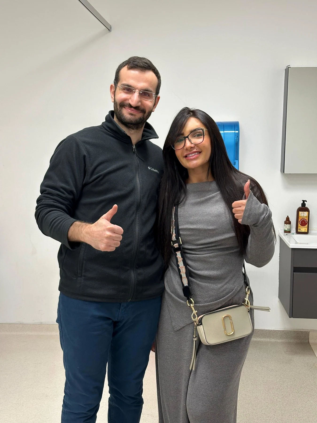 Dr. Ali Sadioğlu and a patient smiling together at the clinic