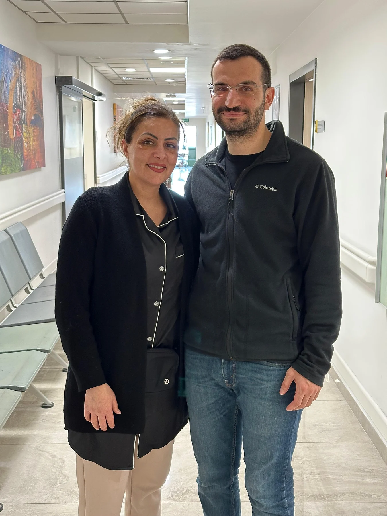 Dr. Ali Sadioğlu with a patient in the hospital corridor