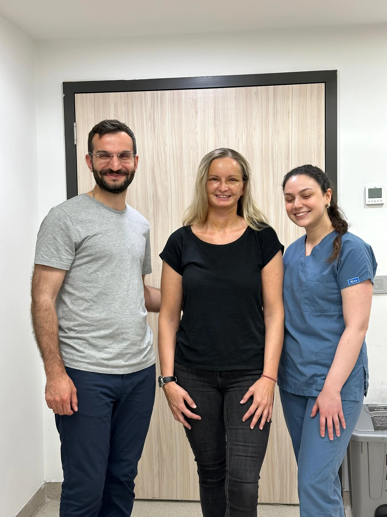 Dr. Ali Sadioğlu with a patient and a member of the clinical team