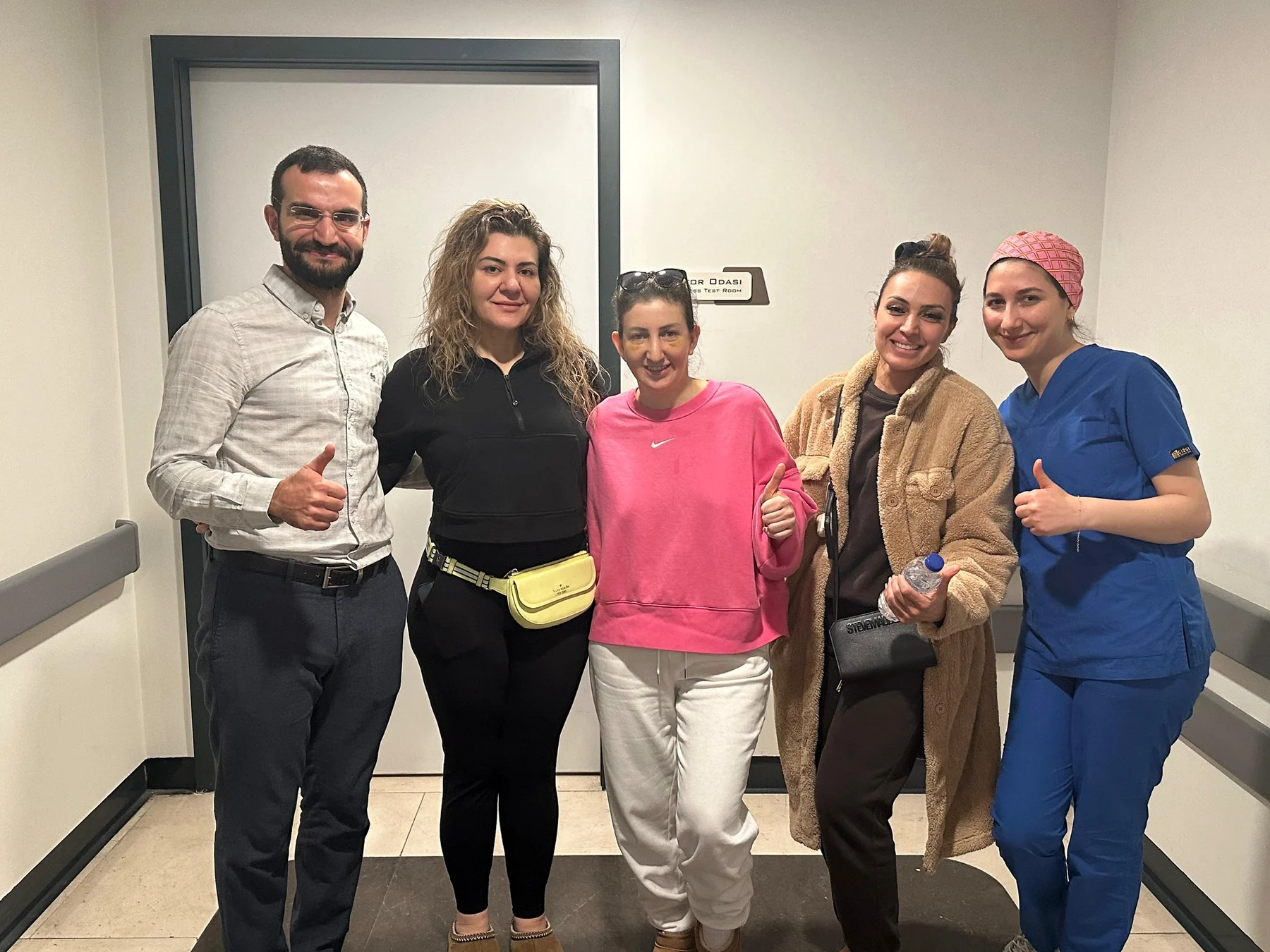 Dr. Ali Sadioğlu with patients and a clinical team member at the hospital
