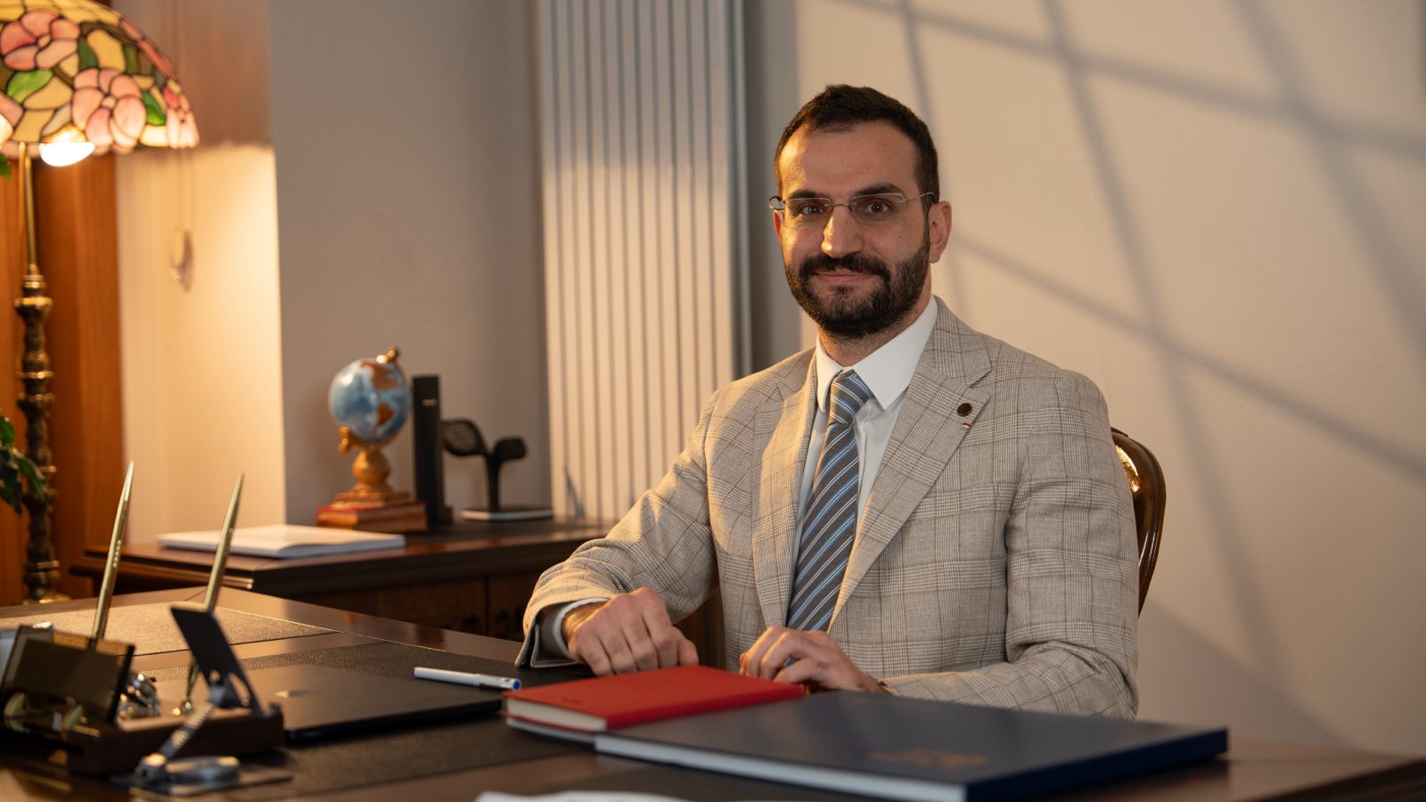 Dr. Ali Sadioğlu at his desk at the practice